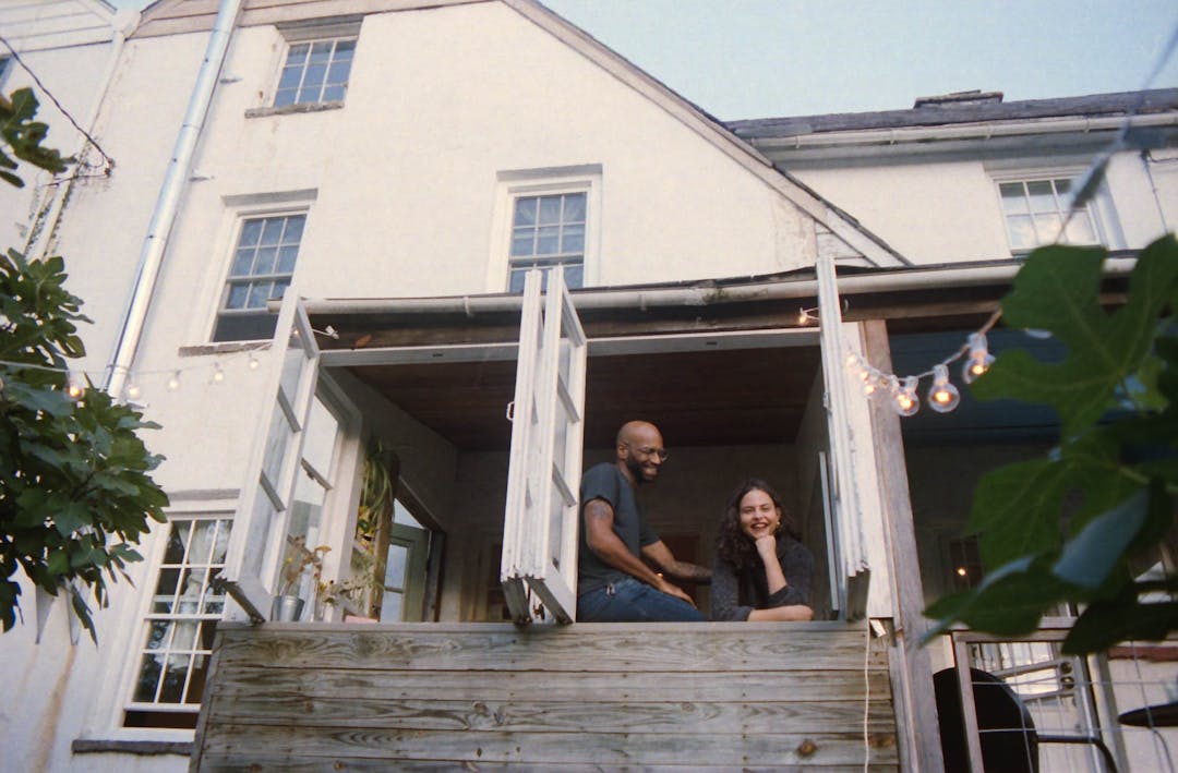 color film photo of couple by windows laughing