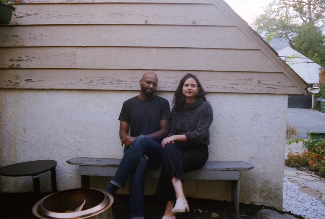 color film photo of couple seated on outdoor bench