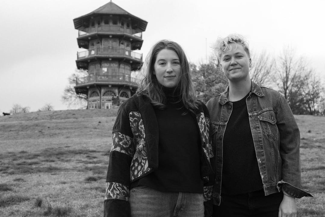 black and white film photo of couple in front of patterson park pagoda in baltimore