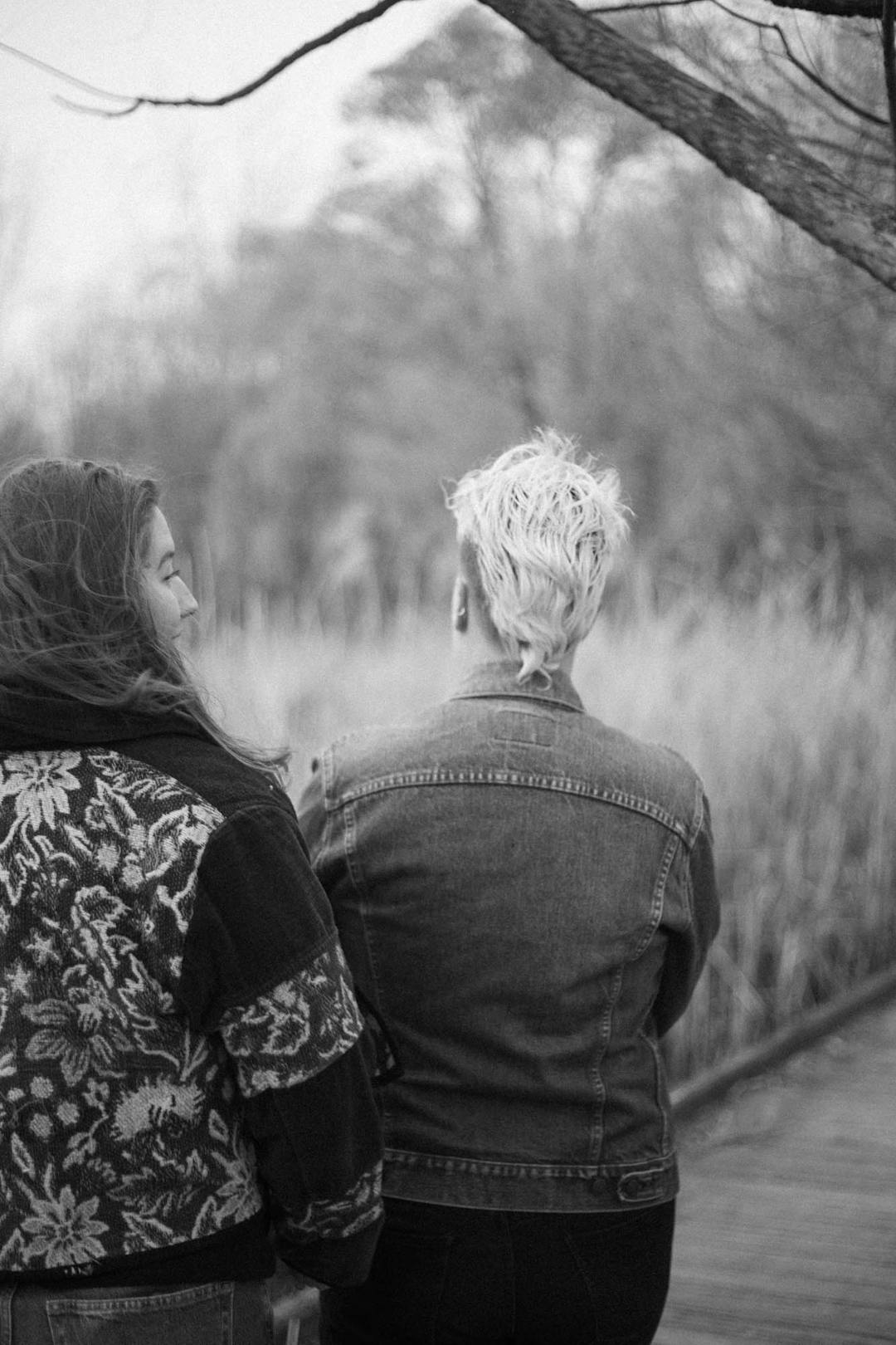 black and white photo of couple from behind on boardwalk at patterson park pagoda in baltimore