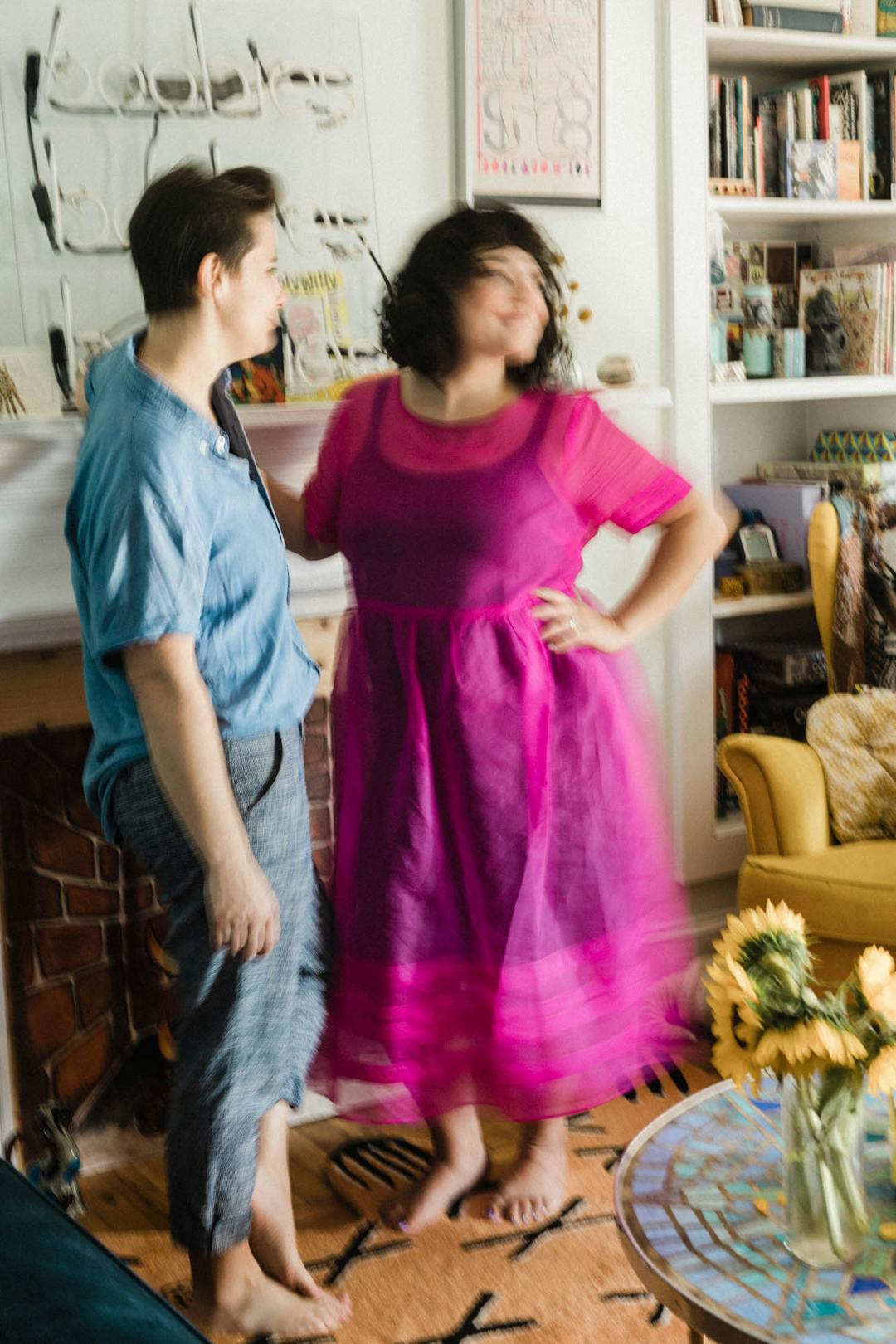 blurry color photo of couple dancing in colorful and art-ful livingroom 